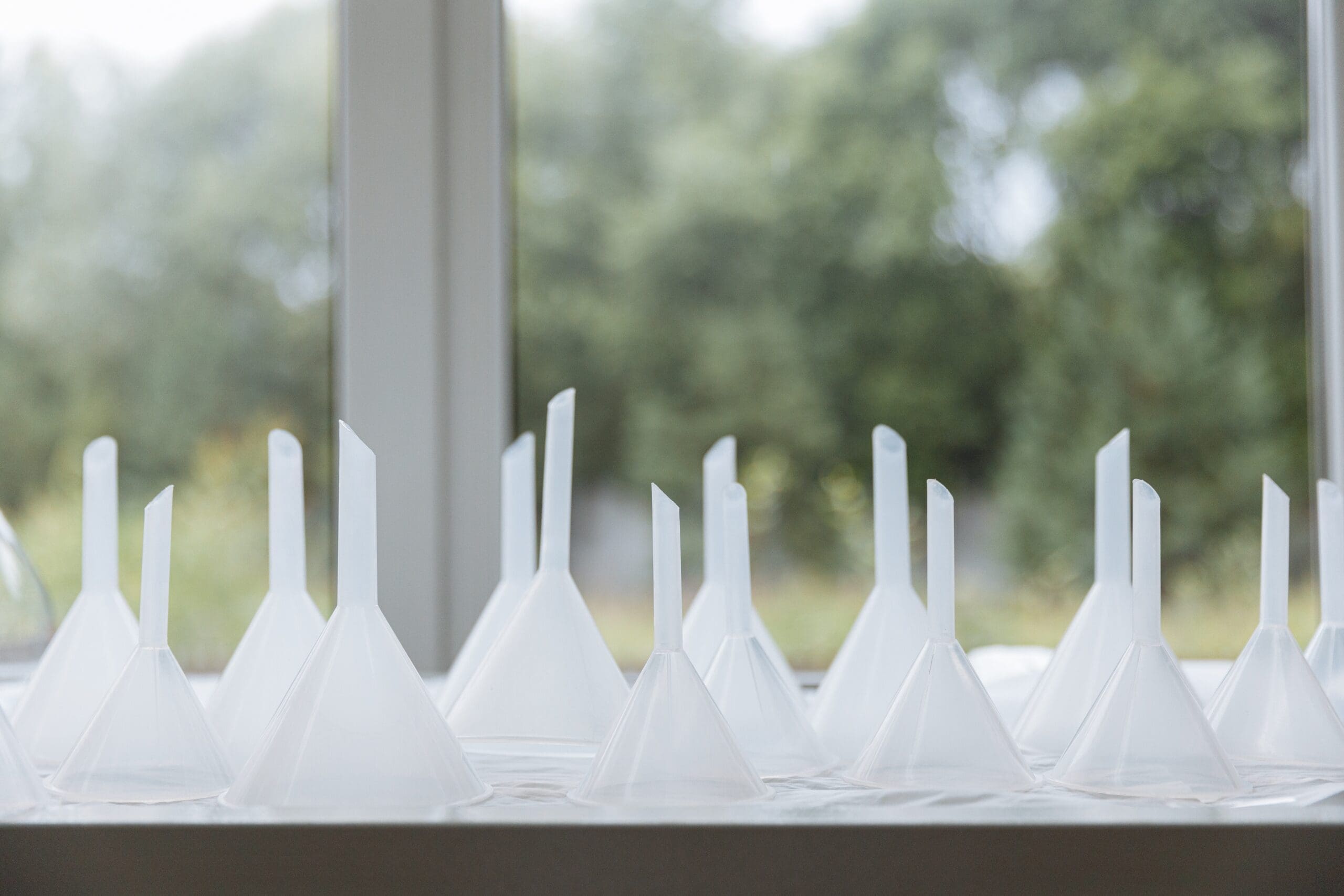 a picture of multiple white funnels kept upside down