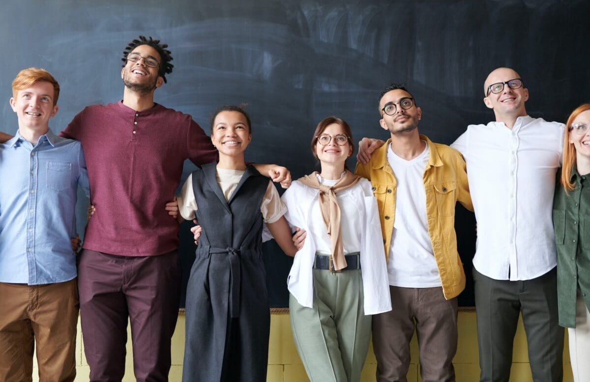 a group of diverse people posing for a photograph, signifying everyman